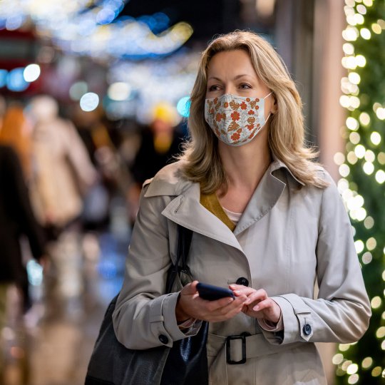 Woman on phone out shopping.
